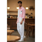 CODE92 pink and white colour-blocked cotton linen shirt with a soft collar worn by a male model in a cafe setting.